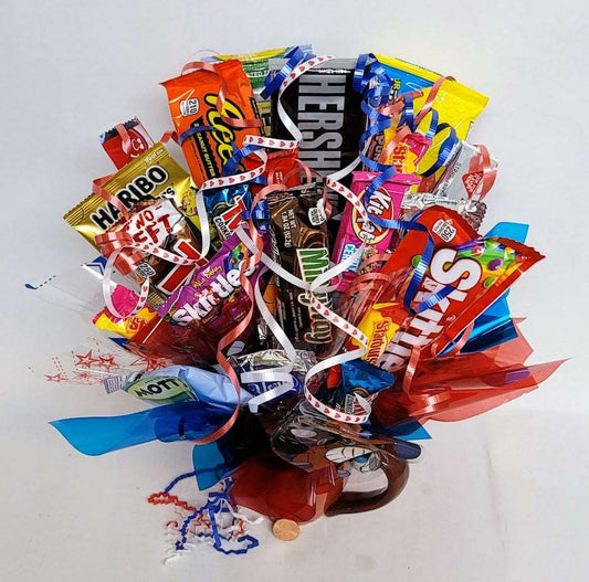 Assortment of candies arranged as a bouquet in a Basketball ceramic mug with colorful ribbons and decorations.
