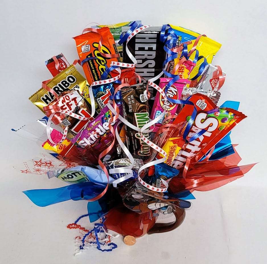 Assortment of candies arranged as a bouquet in a Basketball ceramic mug with colorful ribbons and decorations. 
